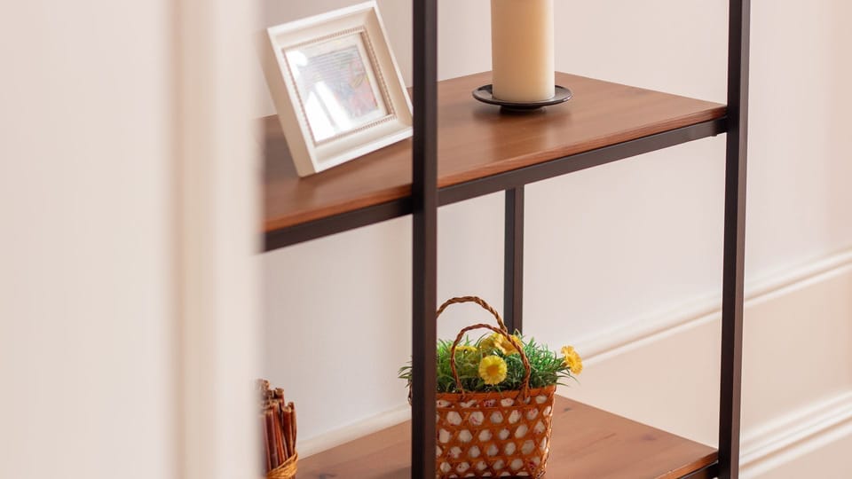 Discover charming decorative touches and a space for your essentials on this elegant shelving unit, blending functionality with thoughtful design.