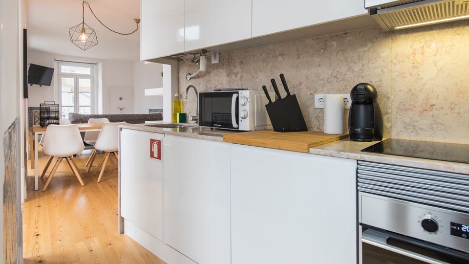 Prepare delightful home-cooked meals in this well-equipped, modern kitchen, featuring sleek countertops and essential appliances. Everything you need is at your fingertips to enjoy culinary creations during your stay.
