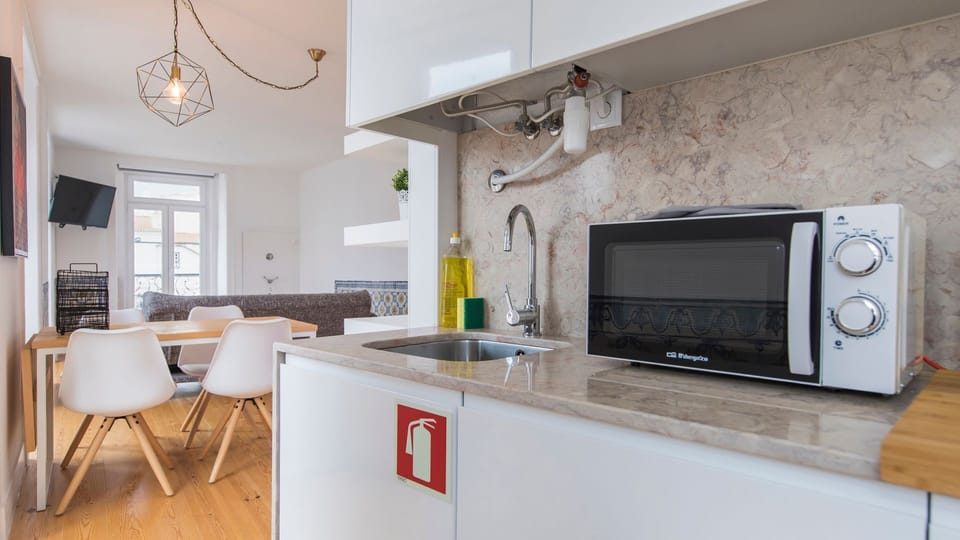 Enjoy the open-plan design where the well-equipped kitchen seamlessly connects to the inviting living area, allowing for easy conversation and shared moments while preparing meals.
