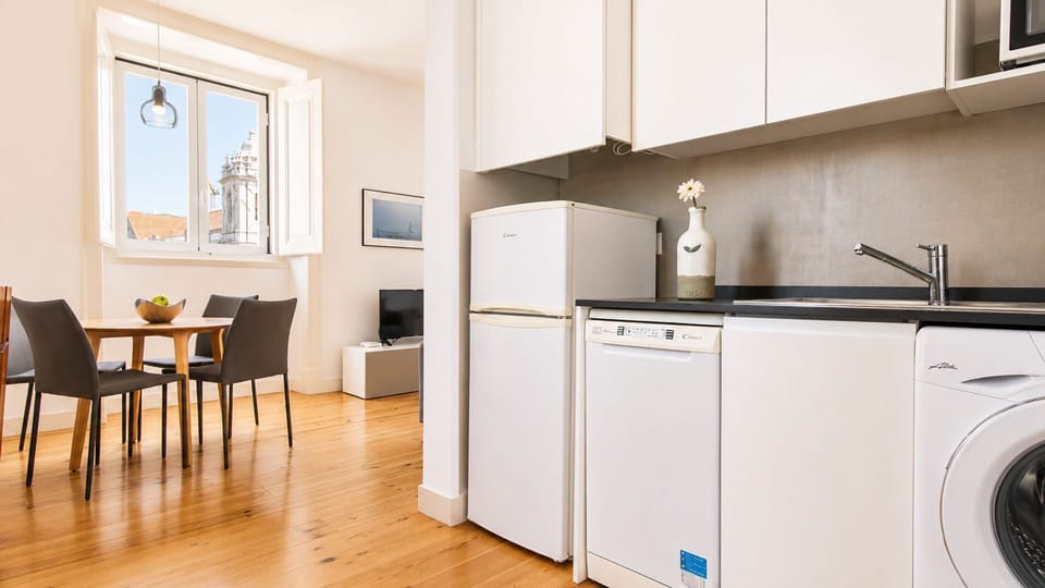 Prepare delicious meals in the well-appointed kitchen, then gather around the bright dining table for memorable conversations. Enjoy the convenience of a fully equipped space that makes self-catering a breeze. #ModernKitchen #DiningArea #CityGlimpse #Brig