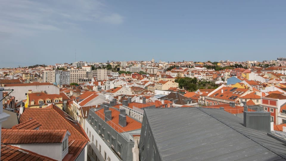Gaze upon the sprawling cityscape with its charming terracotta rooftops, offering a true sense of the vibrant urban landscape. This panoramic view provides a stunning backdrop to your stay, inviting you to explore the city's hidden gems. #CityView #Roofto
