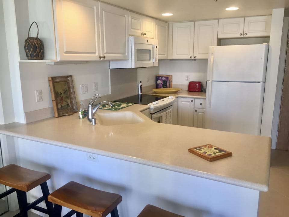 Kitchen with 3 bar stools.
