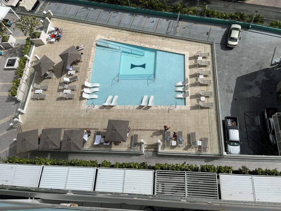 View looking down from the lanai (balcony) of the unit to the lounging pool.