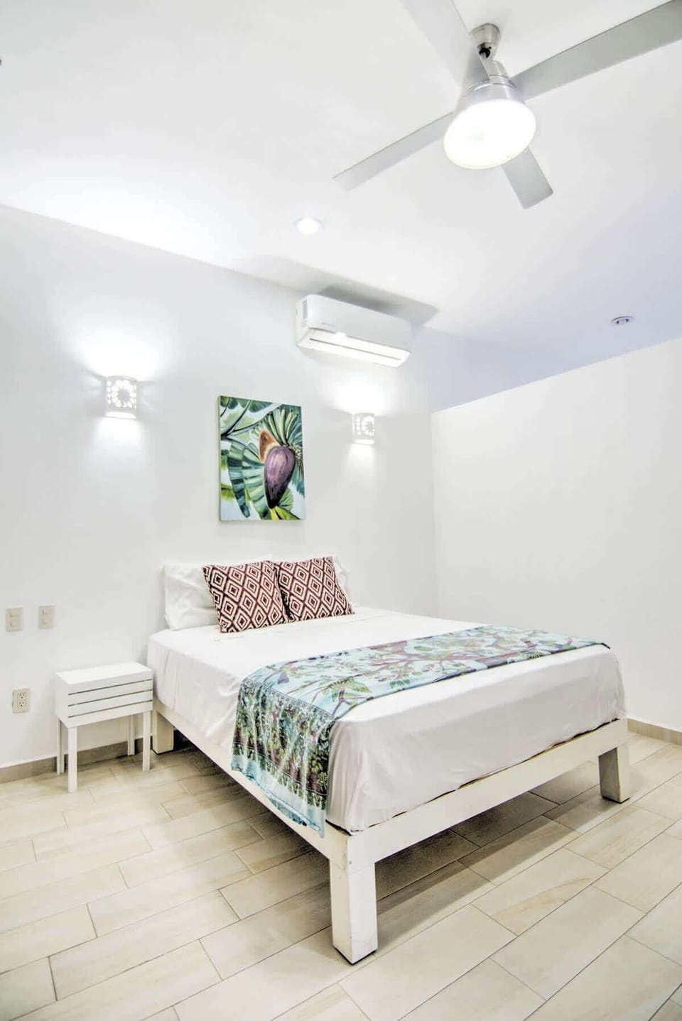 Bedroom with queen-sized bed and walk-in closet