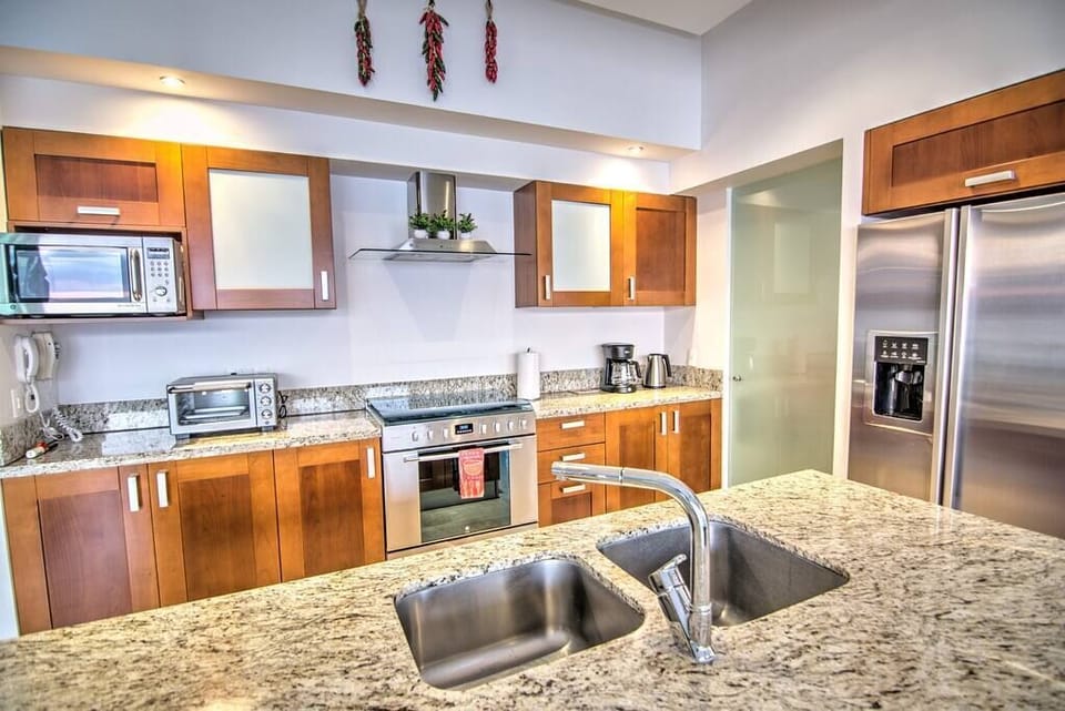 Fully equipped kitchen with granite countertops, stainless steel appliances, filtered tap water, coffee maker, and more!