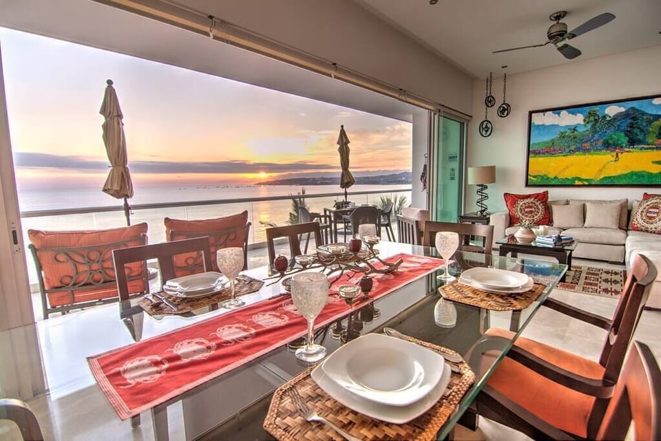 The open concept living area has floor-to-ceiling glass sliding doors that open all the way to offer 180 panoramic views.