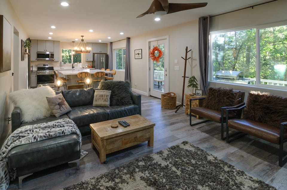 Open kitchen and family room with views of the front deck and surrounding forest