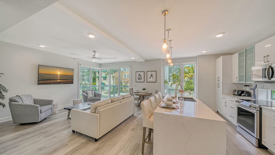 The kitchen and living room with flat screen television. The balcony is on the left.
