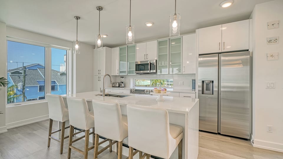 A waterfall-edge island anchors the space with style—and offers four plush seats for casual dining.