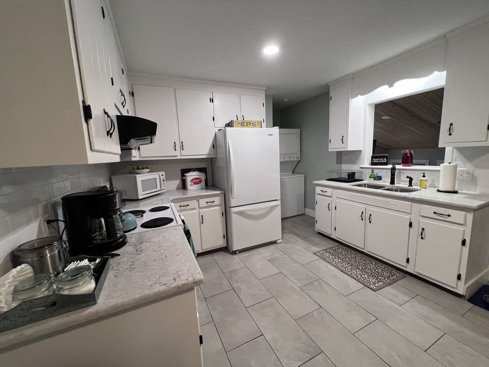 Kitchen with coffee maker, microwave, toaster, full fridge, washer/dryer