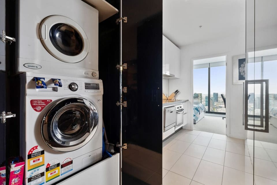Washing machine and dryer in laundry cupboard.