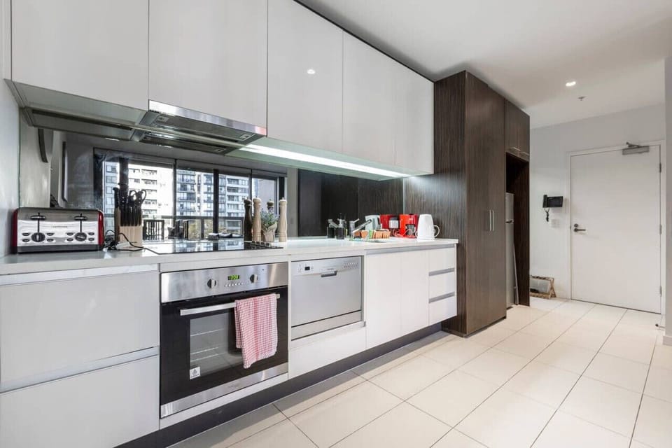 Modern, spacious, self contained kitchen. The microwave oven is positioned on top of the fridge, providing more kitchen bench space.