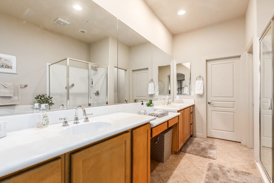 Double sinks and vanity with walk in closet