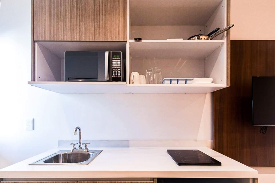 Efficiency meets style in this well-equipped kitchen with a microwave oven.
