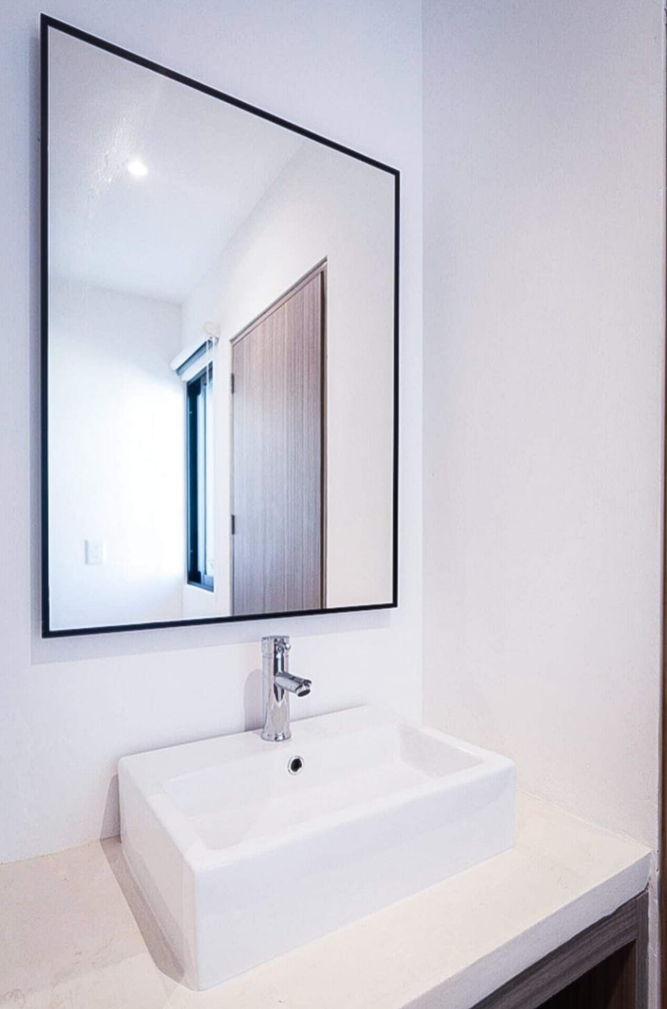 A contemporary bathroom with a stylish sink and mirror, adding functionality and style to this apartment.