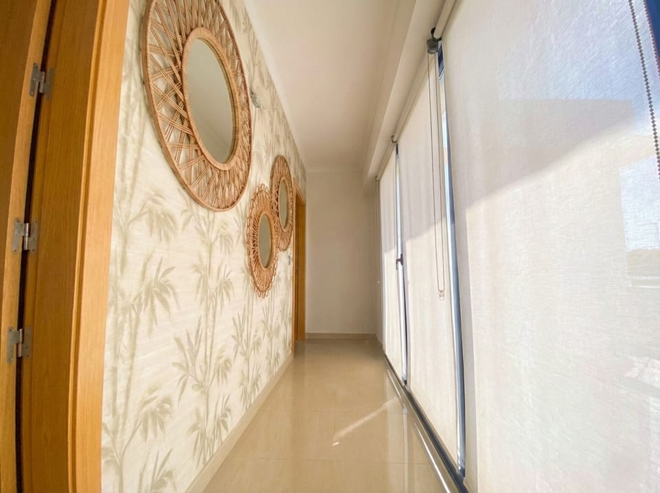 Charming corners: bright hallway decorated with natural fiber mirrors.