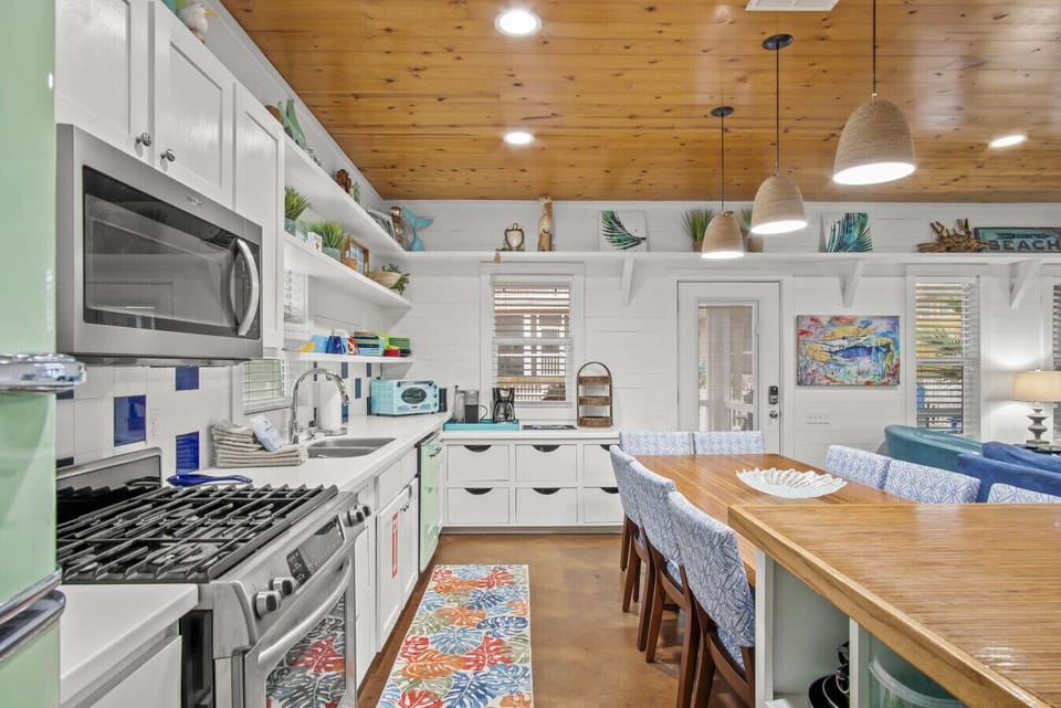 Spacious kitchen with stainless steel appliances and large island seating.