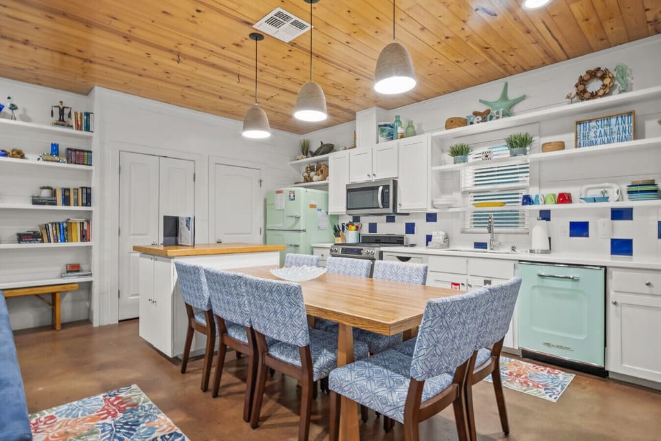 Fully equipped kitchen with modern appliances and spacious dining table.