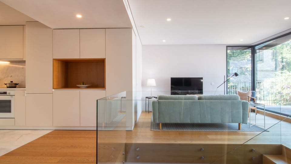 The spacious living area invites relaxation with its comfortable sofa and seamless connection to the modern kitchen.
#LivingRoom #OpenPlan #LovelyStay