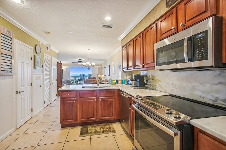 - Bright kitchen with stainless steel appliances and granite counters  
- Open layout connects to dining and living with ocean views  
- Fully equipped for family cooking and extended vacation stays
