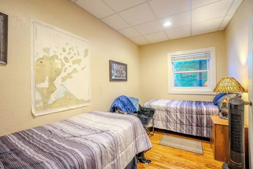 Bedroom 2 features 2 twin beds and a dresser.