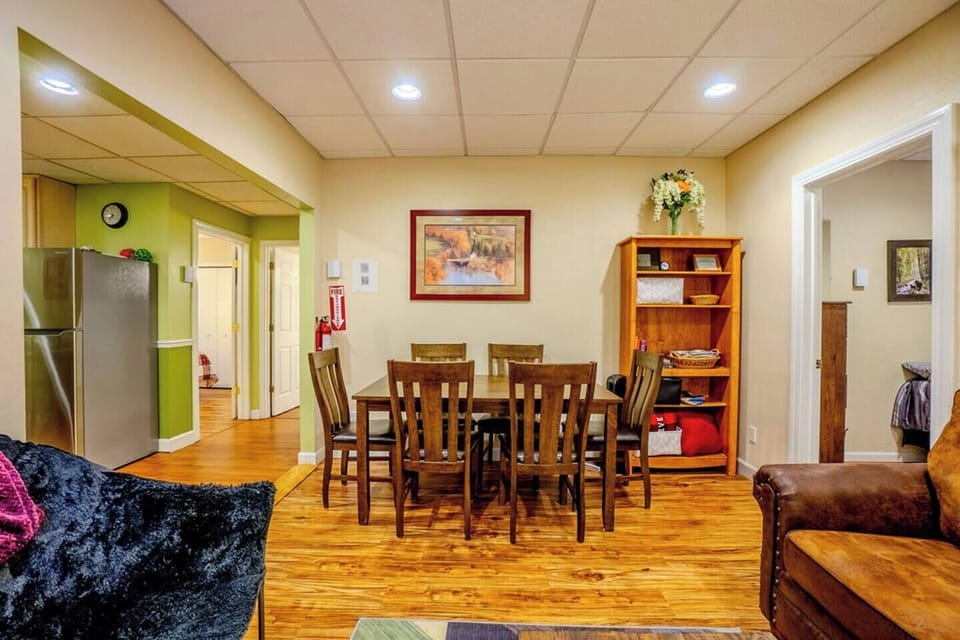 The living room/dining room has a large table with seating for 6 people.