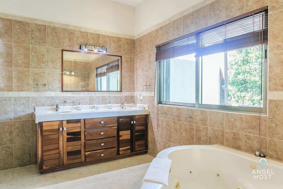 Bedroom 1's bathroom is spacious with a spa tub and loads of natural light.