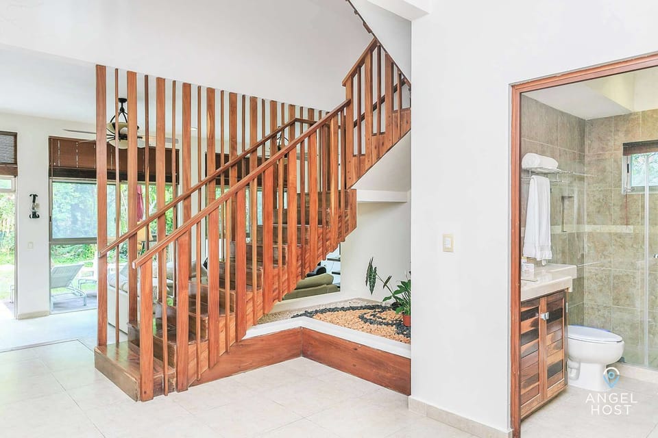 Lovely rock garden at base of stairs and wood accents throughout the home.