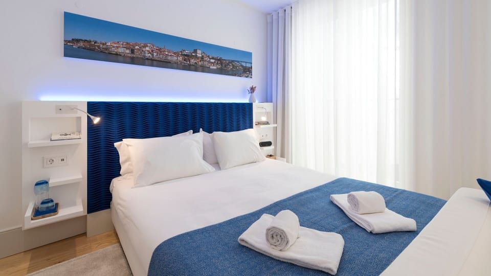 Drift to sleep in the comfort of a plush bed, accented by a deep blue headboard and ambient backlighting.
#Bedroom #ComfortableBed #LovelyStay