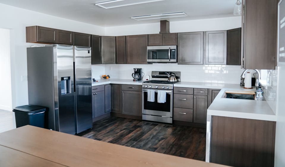 Large fully stocked kitchen with spices and all of the cooking supplies.