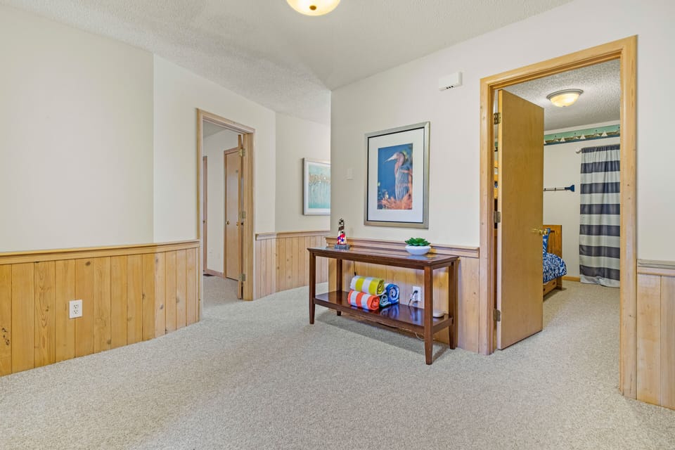 Mid level hall with access to 3 more bedrooms, 2 full baths, & hot tub