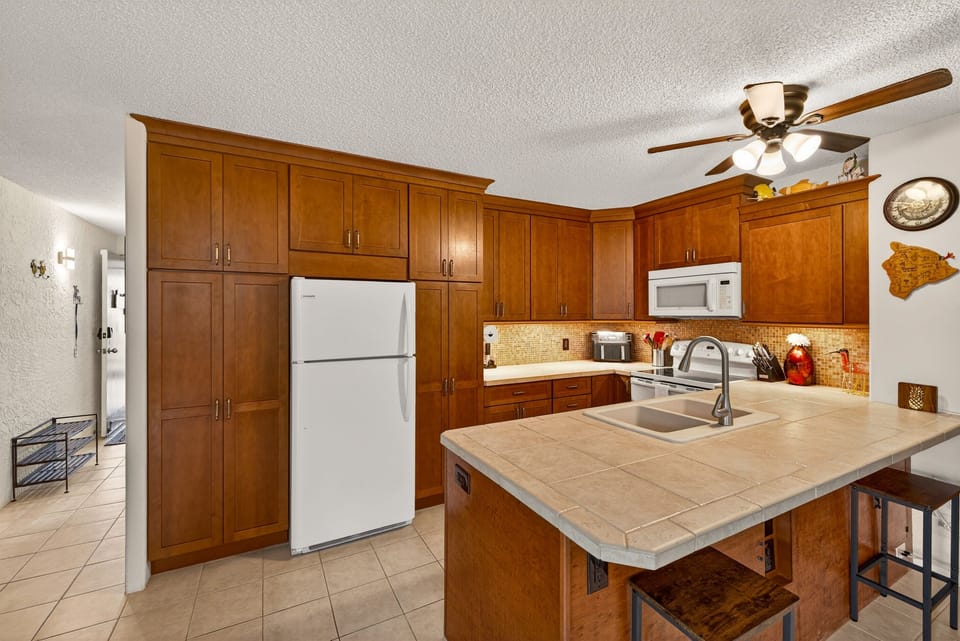 Fully equipped kitchen with generous counter space and island seating—everything you need to prepare meals or entertain at home.