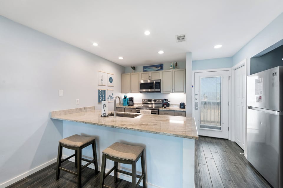 Your fully equipped kitchen features a breakfast bar for casual dining, sleek granite countertops, and all the modern appliances you'll need to whip up your favorite meals.