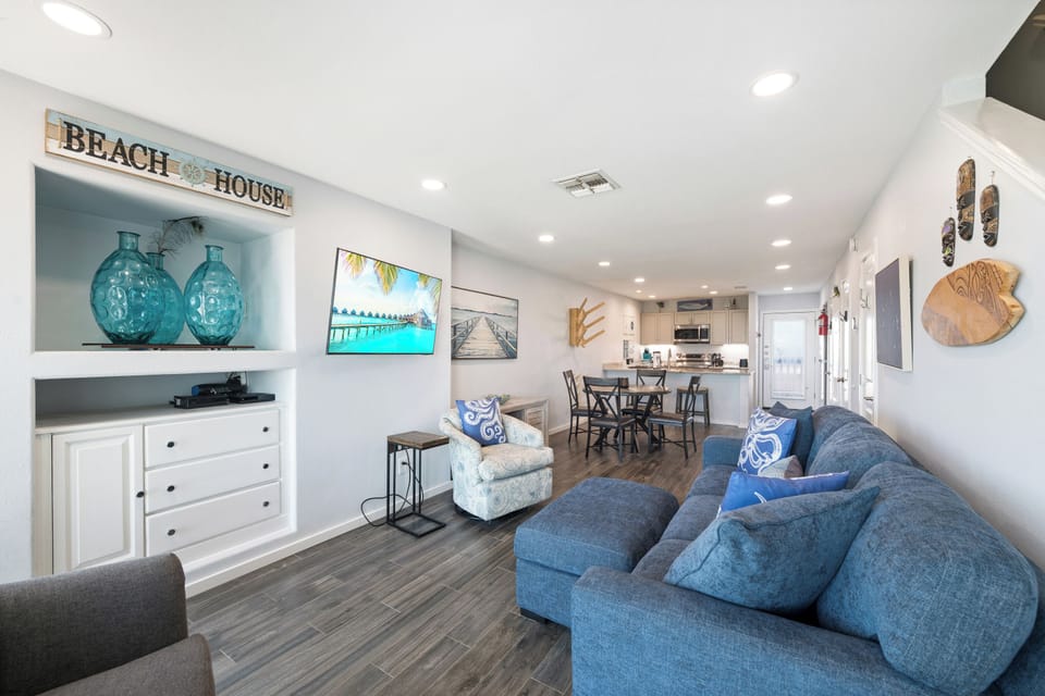 Settle into the plush coastal-inspired living room, where beach decor and soft blues invite you to relax. The open layout connects effortlessly to your dining and kitchen areas for easy living.