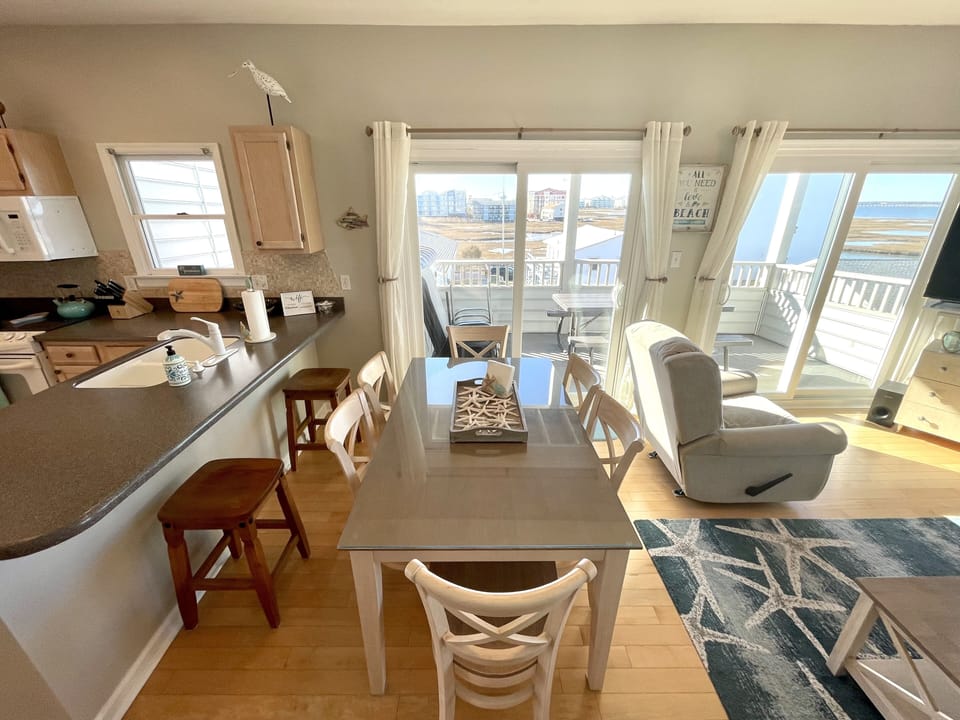 Dining table for 6 and 2 additional bar stools. Picnic table and chairs on deck.
