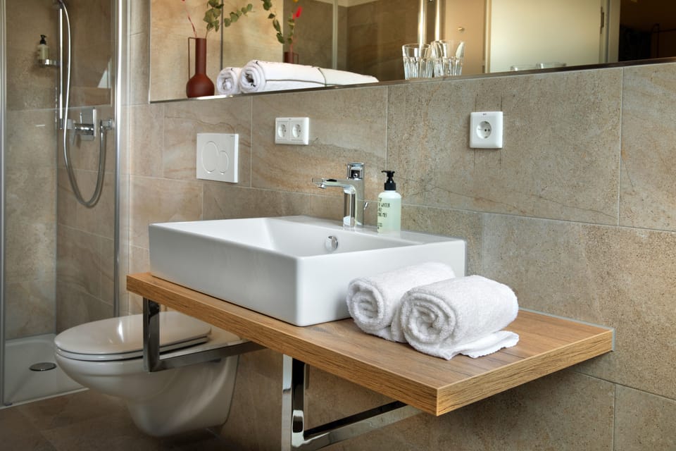 Shower, eco-friendly toiletries, hair dryer, towels