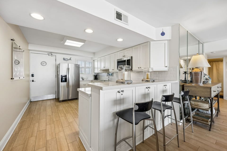 This bright kitchen offers everything you need to feel at home—stainless steel appliances, ample counter space, and a breakfast bar perfect for casual meals or morning coffee.