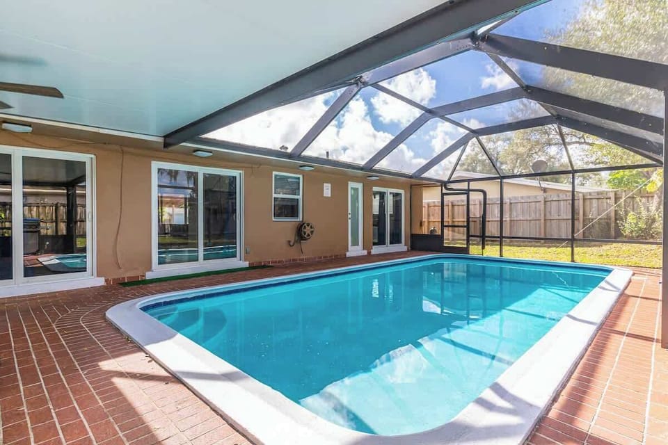 "Serene suburban setting with lush greenery and curved driveway—your tranquil vacation rental awaits!"

