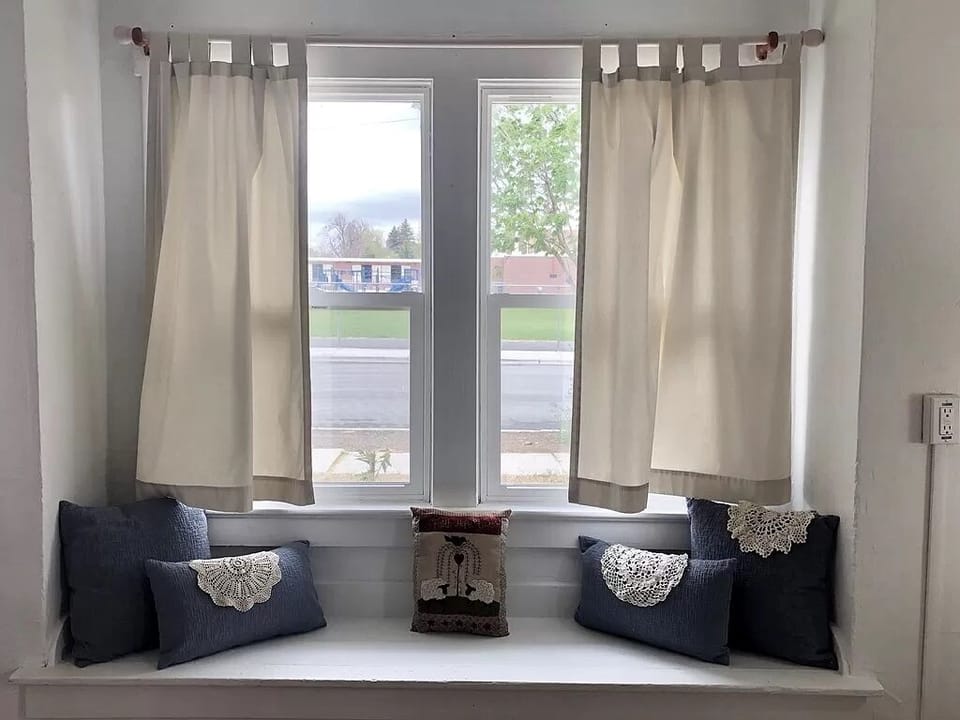 Sunny window bench in the living room is a great spot to curl up with a book