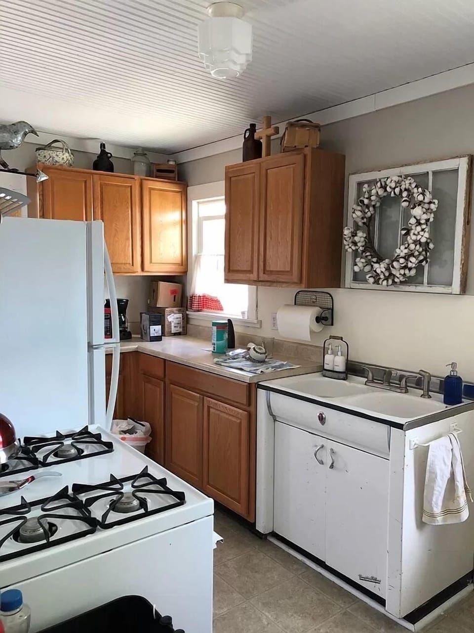 Well-equipped kitchen for preparing meals features a vintage sink