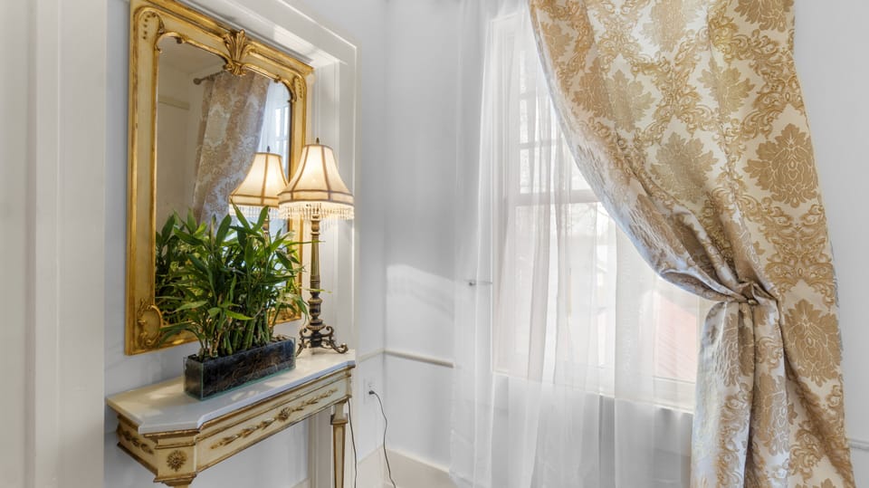 A Pier Mirror at the top of the stairs, across from the Upstairs Bathroom.
