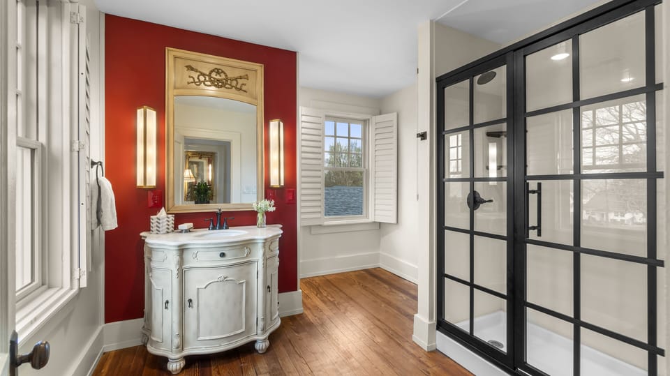 A cayenne red accent wall offsets a generous walk-in shower - Upstairs Full Bath