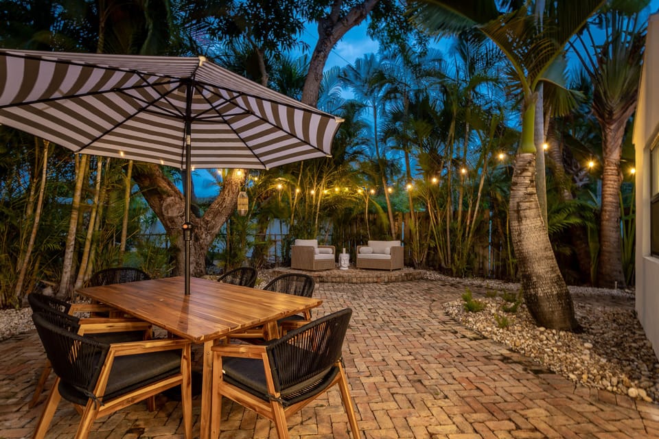 Enjoy exotic cocktails on the Chicago Brick/string-lit romantic backyard