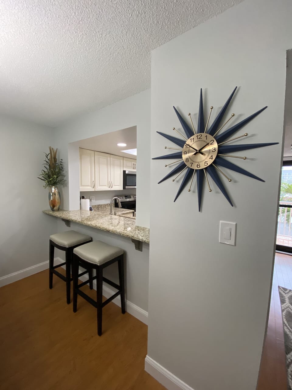 Convenient pass-through kitchen with bar seating.