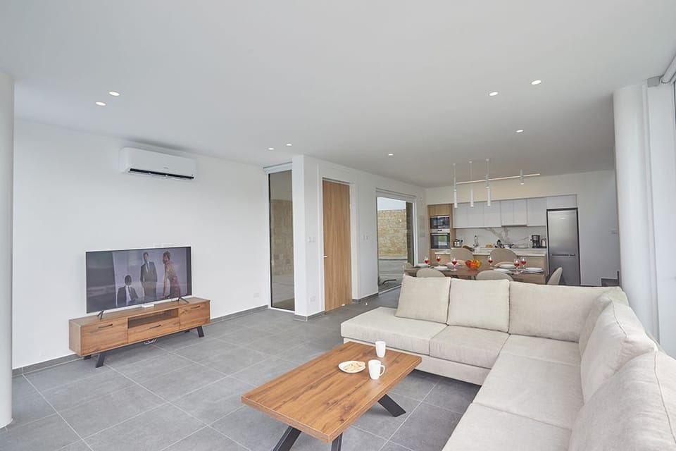 Living room with corner sofa and widescreen Smart TV