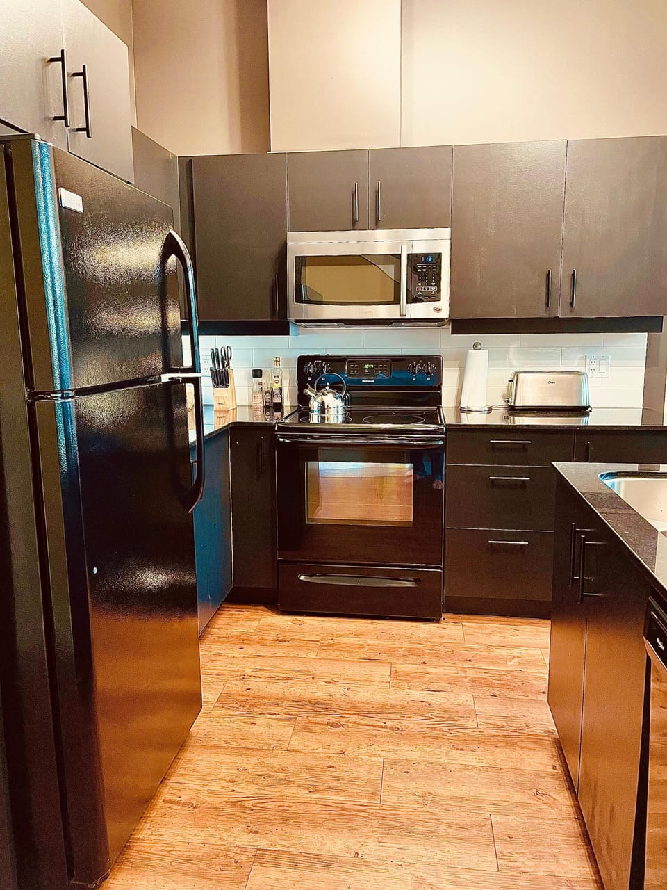 The kitchen, with full size fridge, oven, stove, coffee maker and dishwasher