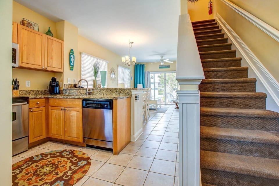 A stairway, conveniently located just off the kitchen, leads to the welcoming upstairs bedrooms.
