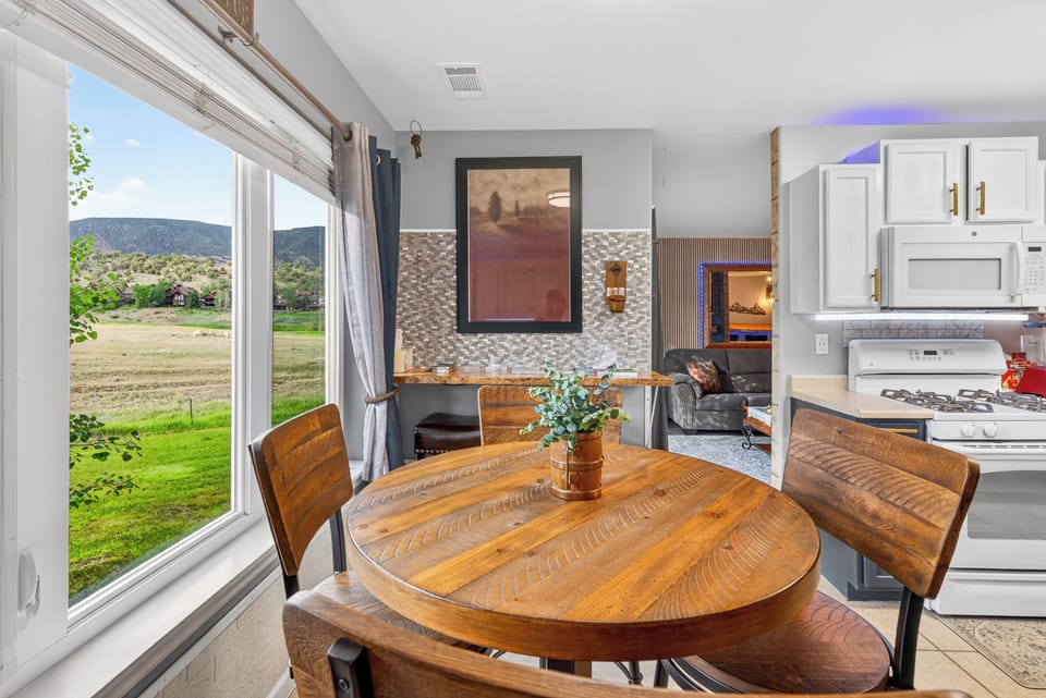 Dual Entry Kitchen: Dining with mountain views & natural Colorado light