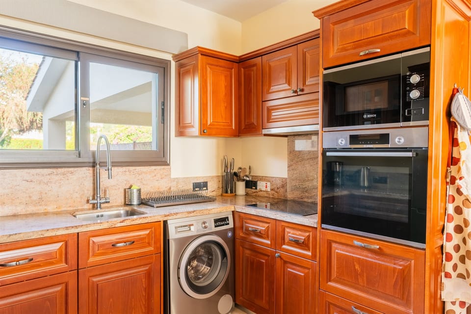 Enjoy cooking in a newly renovated kitchen featuring granite countertops and Bosch appliances, perfect for preparing meals with ease. The open layout connects seamlessly to the living area through a granite bar, making it easy to socialize while you cook.