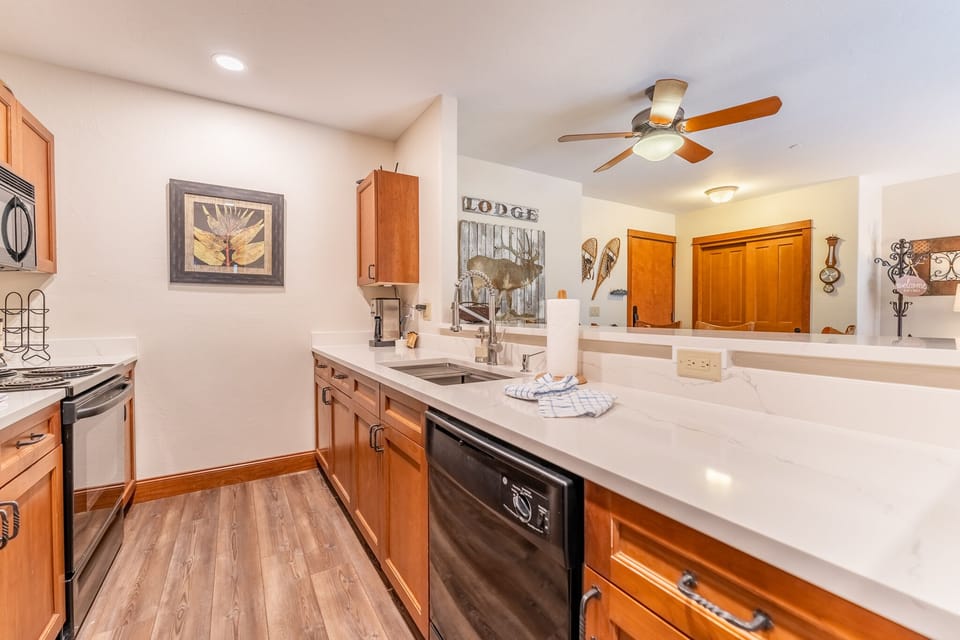 Your fully equipped kitchen features warm wood cabinets, granite counters, and modern appliances—perfect for cooking memorable meals together.